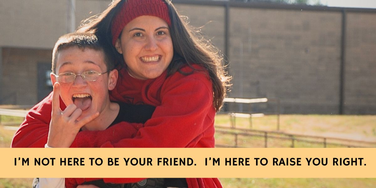Woman and teenage boy hugging and smiling