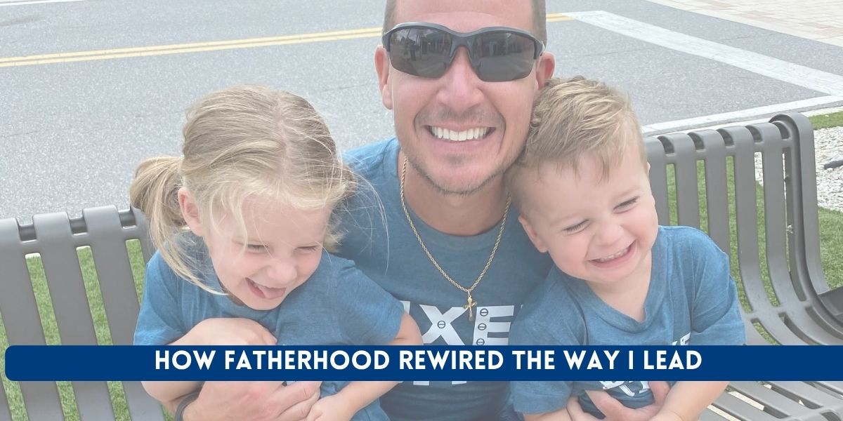 Father carrying his son and daughter while they all laugh together.